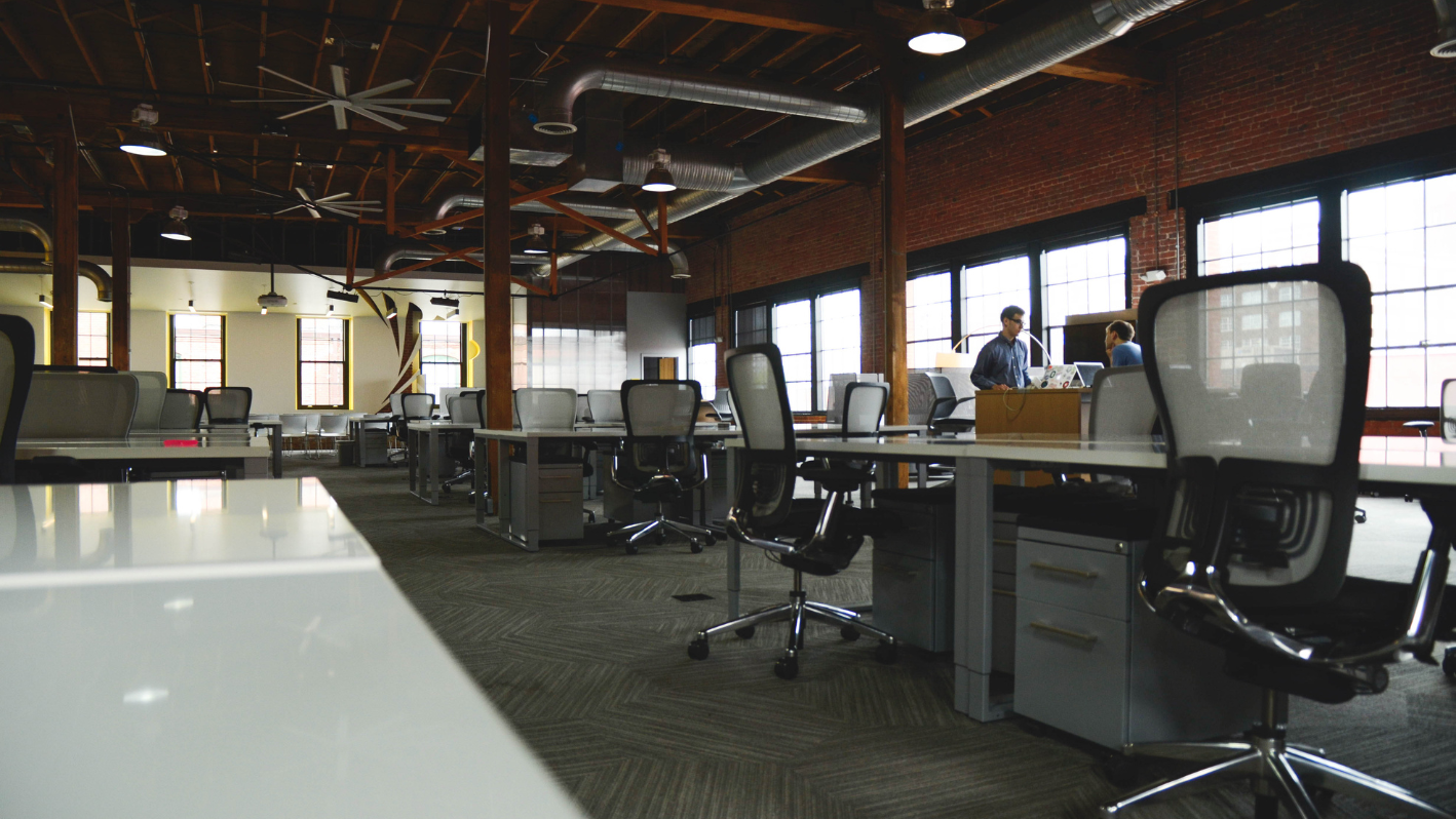 A large open office space with desks and chairs