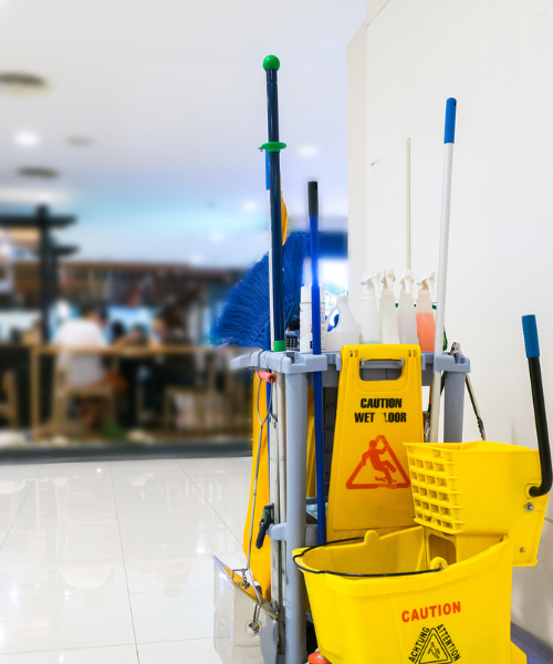 A yellow mop bucket sitting next to a yellow mop bucket